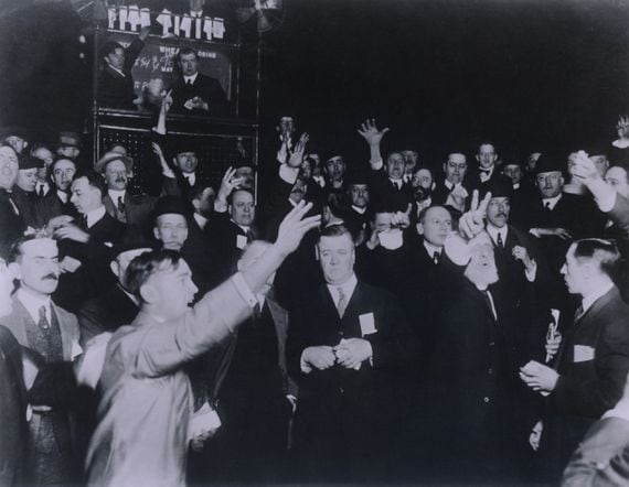 BRISK DEALINGS: “You still have a lot of people who are long that are trying to get out,” says an OTC crypto trader. (Image: Traders in the wheat pit of the Board of Trade in Chicago, 1920, via Shutterstock)
