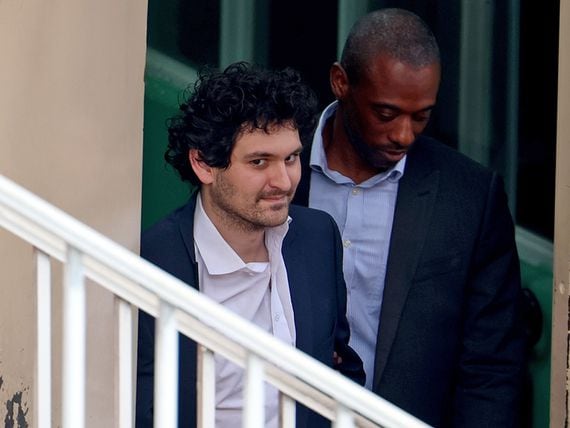 NASSAU, BAHAMAS - DECEMBER 21: FTX co-founder Sam Bankman-Fried is escorted out of the Magistrate's Court on December 21, 2022 in Nassau, Bahamas. The former crypto billionaire is preparing to be extradited to the US from the Bahamas to face charges over FTX’s multi-billion-dollar collapse.  (Photo by Joe Raedle/Getty Images)