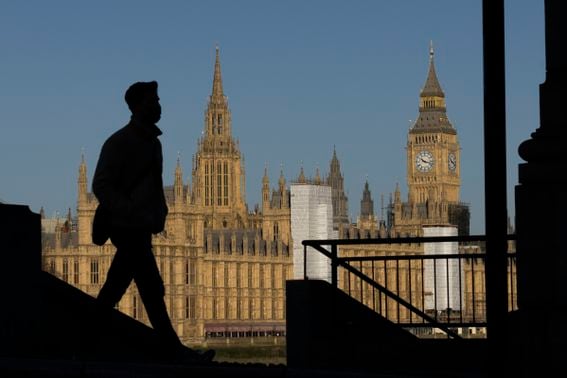 LONDON, ENGLAND - JANUARY 20: A man is silhouetted by the early morning sun as he walks near the Houses of Parliament on January 20, 2022 in London, England. Following a day of political upheaval and shocks yesterday, Prime Minister Boris Johnson appears to have regained some support from members of his party. The defection of MP Christian Wakeford from the Conservative Party to the opposition Labour Party is widely believed to have returned an element of support to Johnson, with anger being deflected away from the recent Downing Street lockdown party accusations. (Photo by Dan Kitwood/Getty Images)