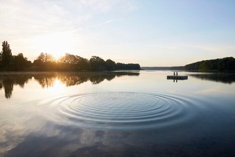 Lake and circular pattern on water surface at sunrise in summer