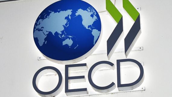 OECD logo of a globe, two chevrons and the letters OECD on display