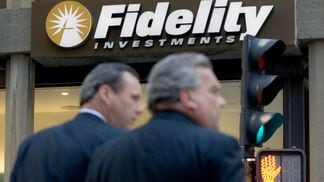 Pedestrians pass a Fidelity Investments office in Boston, Ma