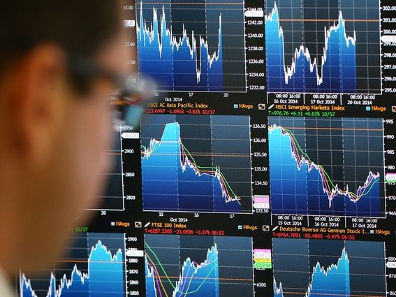 An employee views trading screens at the offices of Panmure Gordon and Co (Carl Court/Getty Images)