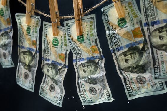 Laundered dollars hanging on a rope (Alexander Sava/Getty Images)