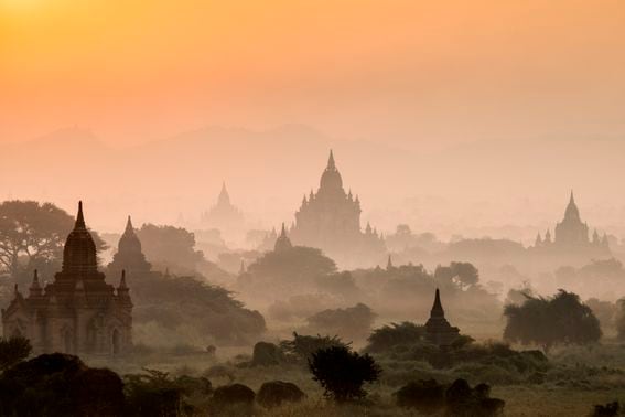 Myanmar, Mandalay division, Bagan, ancient temples shrouded in mist, at sunrise. (Martin Puddy/Getty)