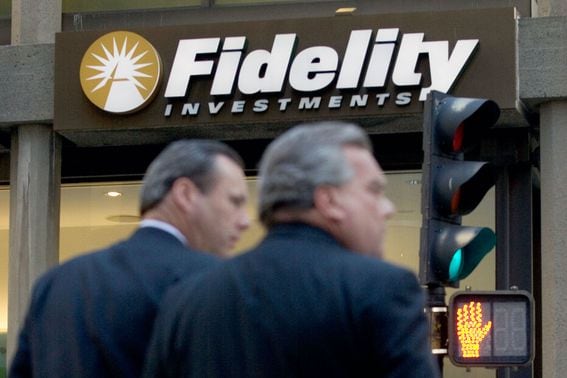 Pedestrians pass a Fidelity Investments office in Boston, Ma