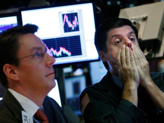 NEW YORK - OCTOBER 07:  A trader rubs his face while working on the floor of the New York Stock Exchange October 7, 2008 in New York City. Despite a government debt buyout plan, the Dow continued to fall today, closing more than 500 points down.  (Photo by Mario Tama/Getty Images)