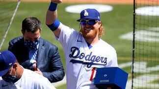 Justin Turner of the Los Angeles Dodgers acknowledges the crowd after receiving his World Series ring at Dodger Stadium on April 9, 2021.
