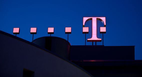The logo of the German telecoms provider Deutsche Telekom is pictured at twilight at the company's headquarters on March 09, 2010 in Bonn, Germany.