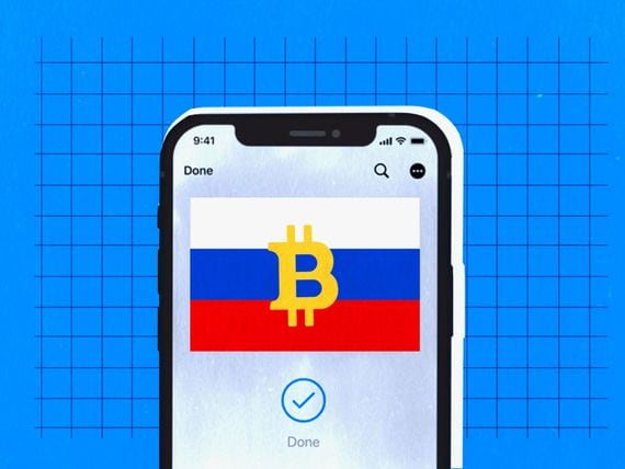 A cell phone with the Russian flag, bitcoin logo and checkmark indicating a payment is "done"