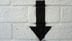 Down Arrow spray painted on a brick wall (Shutterstock)