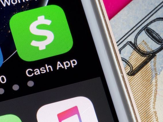 CDCROP: CASH app on Smartphone next to $100 dollar bill (Shutterstock)