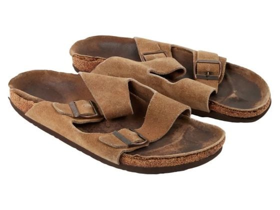 CDCROP: Sold for $218,750. A pair of brown suede leather Birkenstock Arizona sandals that were personally owned and worn by Steve Jobs. (Julien's Auctions)