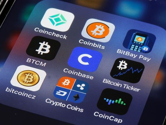 PARIS, FRANCE - APRIL 12: In this photo illustration, the logo of the Coinbase cryptocurrency exchange app (C) is displayed on the screen of an iPhone on April 12, 2021 in Paris, France. Coinbase, America's leading cryptocurrency exchange, arrives on Wall Street on Wednesday April 14 as part of a 'direct introduction'. An IPO, eagerly awaited by crypto enthusiasts, which could value the Californian company at more than 100 billion dollars. Taking advantage of exploding demand for digital currencies, Coinbase said last week that it expects to make a profit of $730 million to $800 million in the first quarter of 2021, more than double the total profit in 2020. Revenues for the first three months of 2021 have likely exceeded last year's, to nearly $1.8 billion. (Photo by Chesnot/Getty Images)