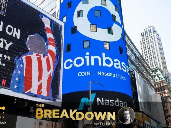 A large sign displays Coinbase images during the company's direct listing day at the Nasdaq MarketSite in New York.
