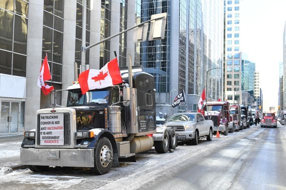 Truckers line up their trucks on Albert Street as they honk their horns on February 5, 2022 in Ottawa, Canada. The trucker blockade has since been dispersed - in part through the use of financial seizures and censorship. (Minas Panagiotakis/Getty Images)