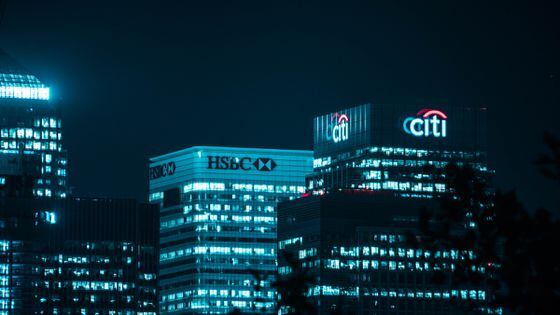 Citi bank and HSBC skyscrapers at night (Miquel Parera/Unsplash)