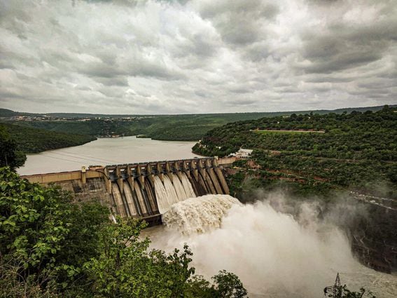 A dam with rushing water (Rahul Pabolu/Unsplash)