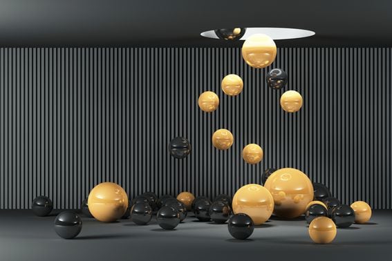 3d illustration of many black and yellow balls falling from ceiling on black background. 3d rendering