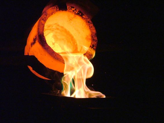 Liquid gold being poured into a cast to make a bullion bar at a Gold Reef City demonstration. Even the crucible glows under the immense heat (via Wiki commons).