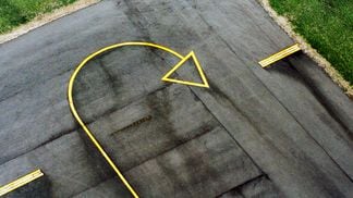 CDCROP: Yellow arrow sign on airport runway, aerial view (Getty Images)