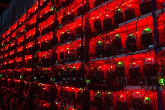 Illuminated racks of application-specific integrated circuit (ASIC) mining devices  at the BitCluster cryptocurrency mining farm in Norilsk, Russia. 