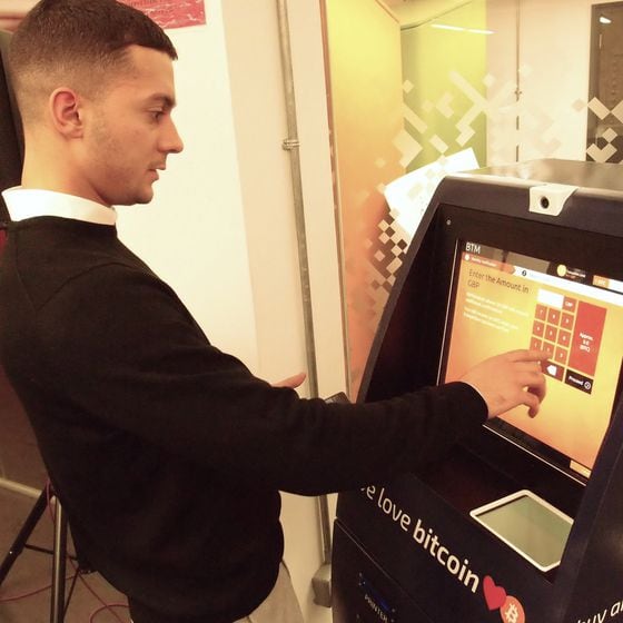  Myles Cirjanic-Edwards of Bitbuddy performing a transaction at his ATM.