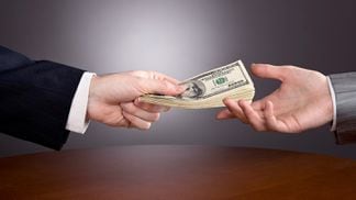 Lending money handing over paying cash (Shutterstock)
