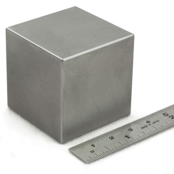 This four-inch tungsten cube weighs as much as those ridiculously huge dumbells at the far end of the rack – a whopping 40 pounds. (Midwest Tungsten)