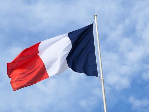 The national flag of France and cloudy sky