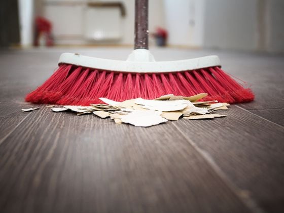 Sweeping floor with broom
