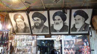 Images of Hassan Nasrallah and Sayyid Ruhollah Musavi Khomeini adorn the walls of a Syrian market. (Leif Stenberg/Shutterstock)