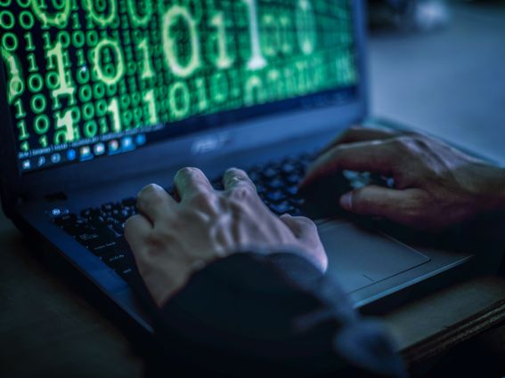 Hacker stealing password and identity, computer crime. (boonchai wedmakawand/Getty Images)