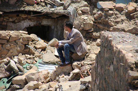 A Yemeni sitting on a destroyed house. (Credit: Shutterstock / akramalrasny)