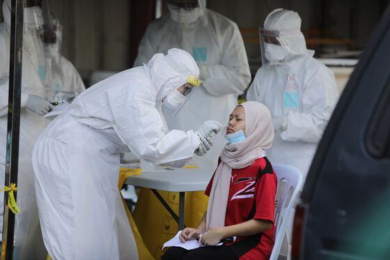 A health worker conducts a COVID-19 test in Kuala Lumpur, April 12, 2020. (Credit: Shutterstock)