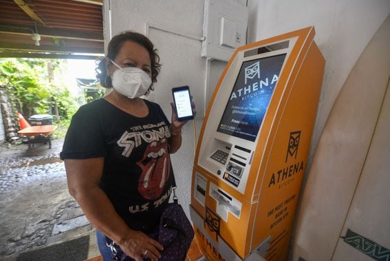A woman displays a bitcoin wallet on June 16, 2021 in Chiltuipan, El Salvador. Though sometimes affiliated with the Western far right, Bitcoin has been embraced across a broad geographical and political spectrum. (Camilo Freedman/Getty Images)