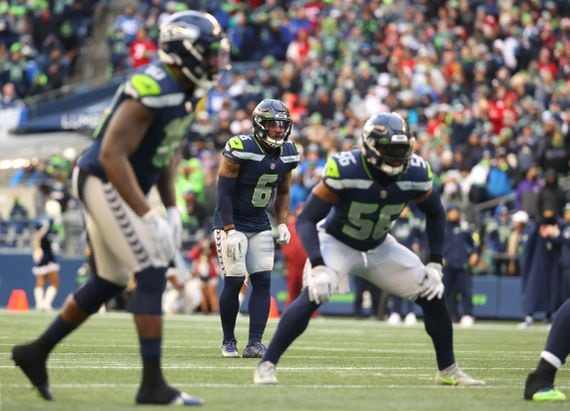 SEATTLE, WASHINGTON - DECEMBER 05: Benson Mayowa #10, Quandre Diggs #6 and Jordyn Brooks #56 of the Seattle Seahawks line up for play against the San Francisco 49ers during the third quarter at Lumen Field on December 05, 2021 in Seattle, Washington. (Photo by Abbie Parr/Getty Images)
