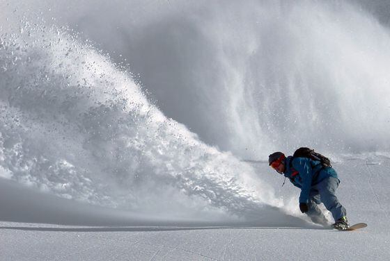 Avalanche, snowboarder totally shredding