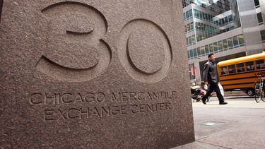 A pedestrian passes a sign outside the building which houses the Chicago Mercantile Exchange (Scott Olson/Getty Images)