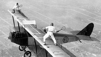 Gladys Roy plays tennis with Ivan Unger (member of the "Flying Black Hats") as Frank Tomac pilots the plane at 3,000 feet. The only problem with this match is trying to retrieve a ball after it has bounced off the wing of the plane and plunged a few thousand feet.