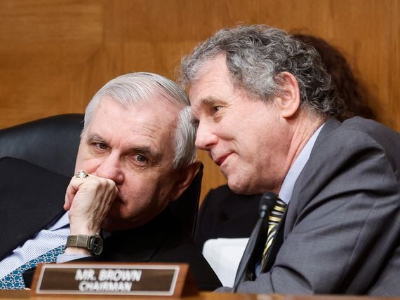 WASHINGTON, DC - MARCH 03: U.S. Senator Jack Reed (D -RI) confers with Senate Banking, Housing, and Urban Affairs Committee Chairman Sherrod Brown (D-OH) during a Senate Banking, Housing, and Urban Affairs Committee hearing on the Fed's "Semiannual Monetary Policy Report to the Congress," on Capitol Hill on March 3, 2022 in Washington, DC. (Photo by Jonathan Ernst-Pool/Getty Images)