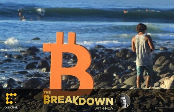 Photo of a large physical bitcoin logo on the rocky beach of Bitcoin Beach, El Salvador. Today’s episode is with the project’s director, Mike Peterson.