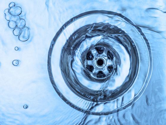 CDCROP: Drain water going down downwards spiral (Shutterstock)