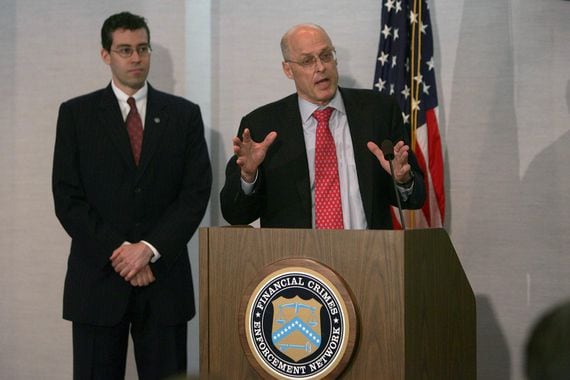 Former FinCEN Director James Freis (left) and former Treasury Secretary Henry Paulson (Dennis Brack/Bloomberg via Getty Images)