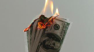 Money to burn cash on fire (Jp Valery/Unsplash)