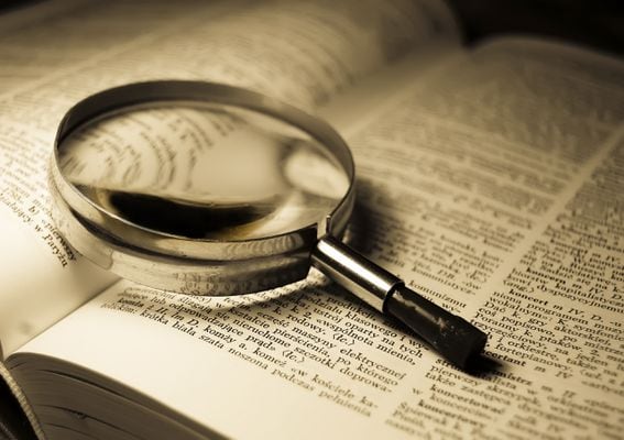 dictionary, magnifying glass