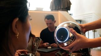 A user from GCR getting their iris scanned with a Worldcoin Orb in Paris on July 21. (Eliza Gkritsi/CoinDesk)