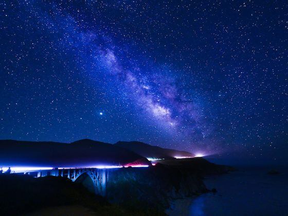 A distant bridge under a starry sky
