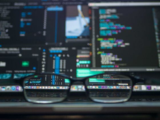 Glasses in front of a screen. (Kevin Ku/Unsplash)