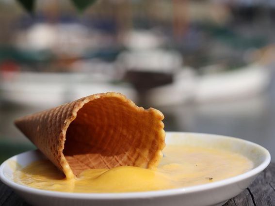 A waffle cone in a dish of melted ice cream, representing Bitcoin's summer markets.